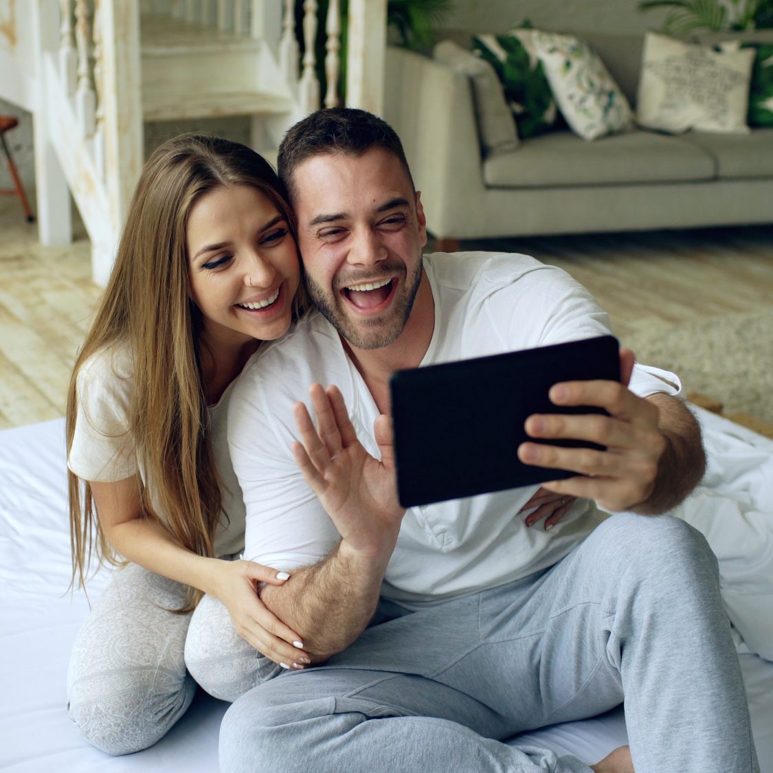 Happy couple skyping with others who are part of the Ridiculously Effective Parenting Training