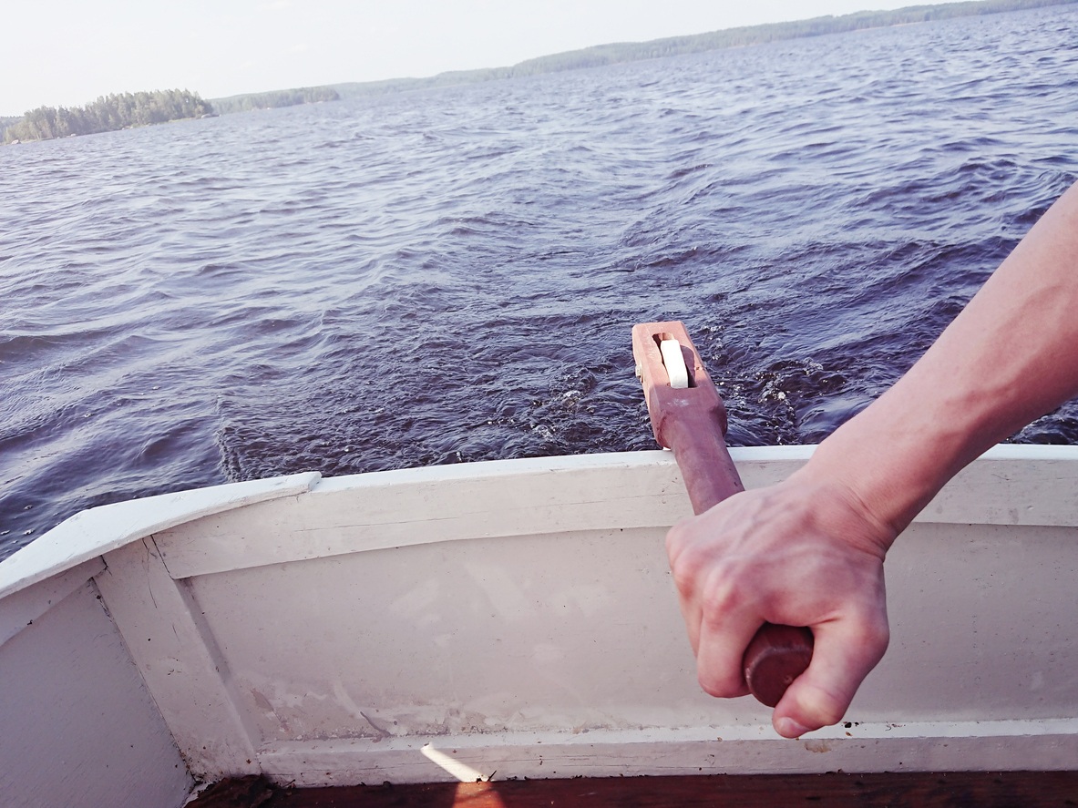 A hand holding tightly to the rudder.