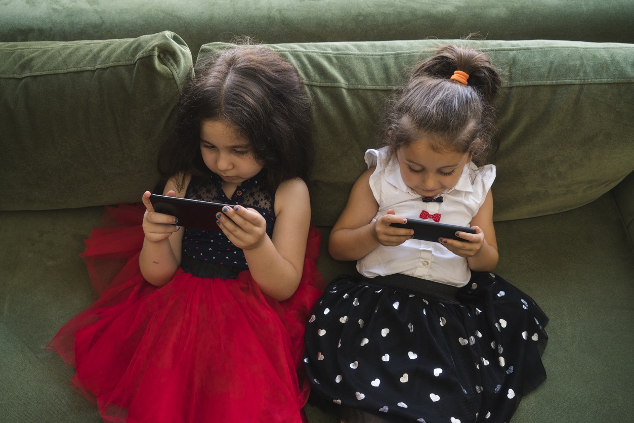 Young girls using cell phones.