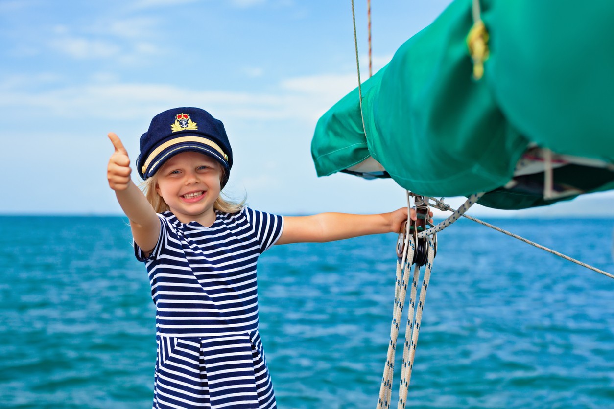 Happy child on a sail boat.