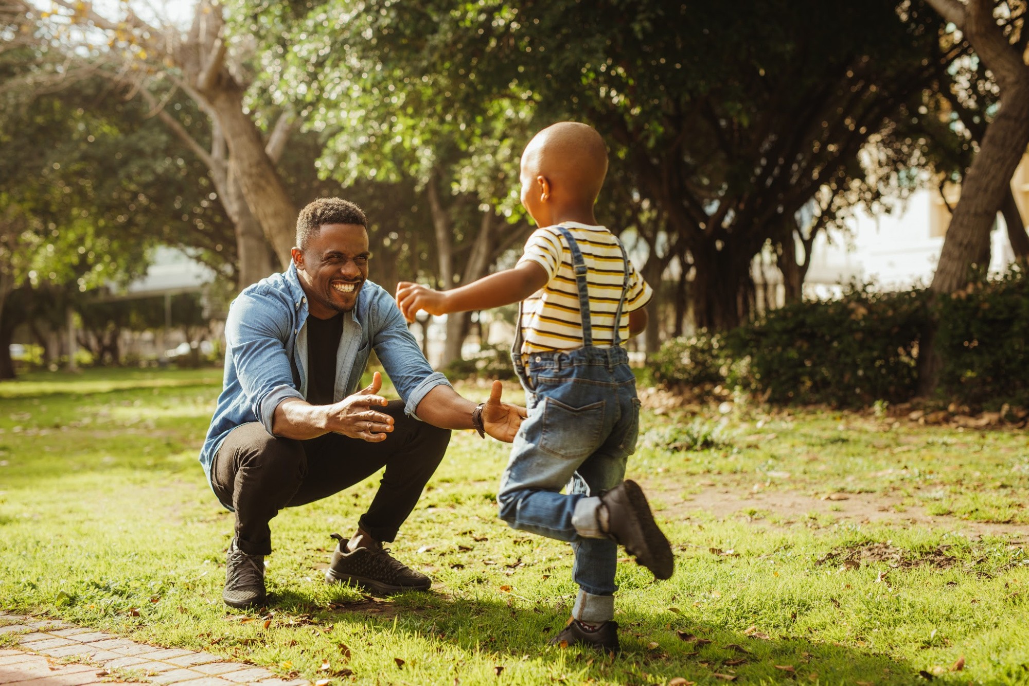 Cute son running into father's arms.