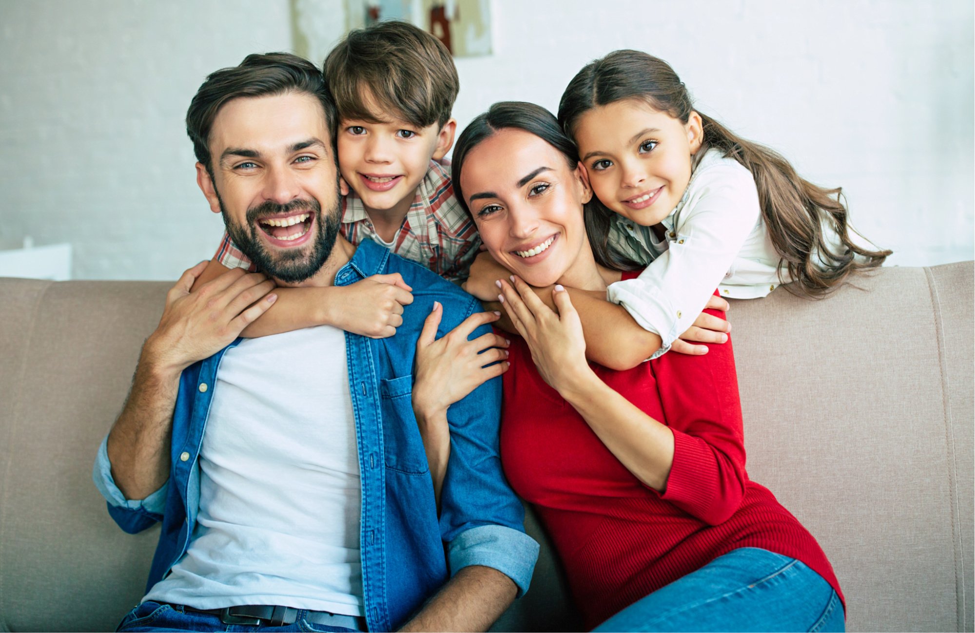 Loving family sitting on a couch.