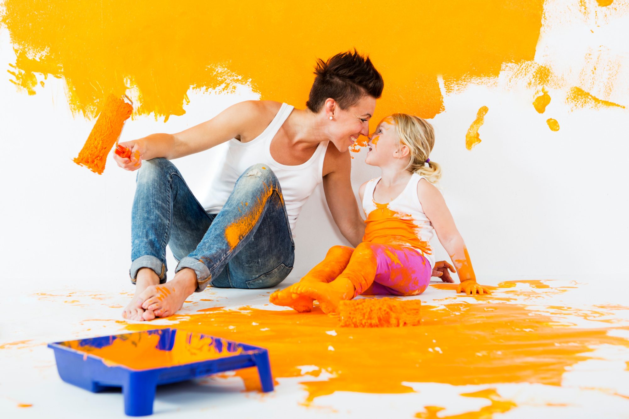 Mother and daughter painting a wall together