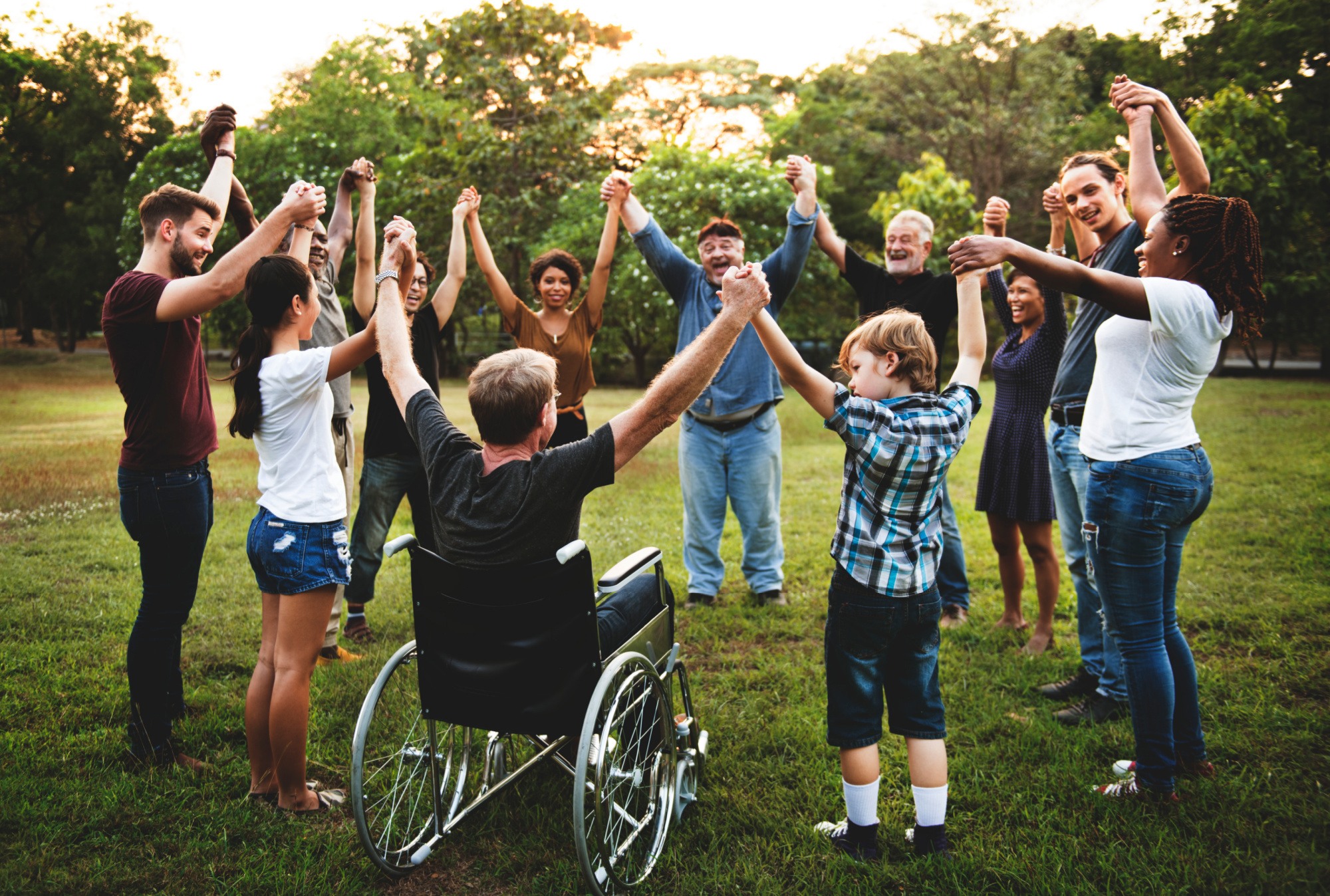 Group of people holding hand together in the park