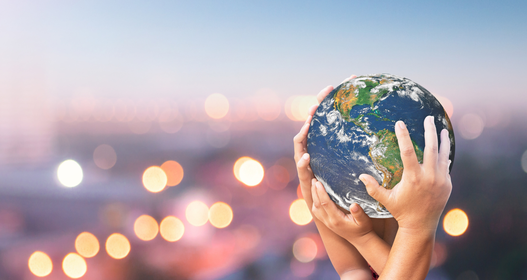 Adult and child holding a world globe.