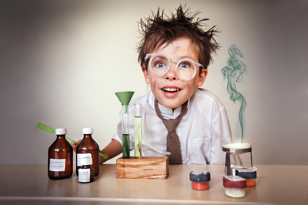 Crazy scientist. Young boy performing experiments