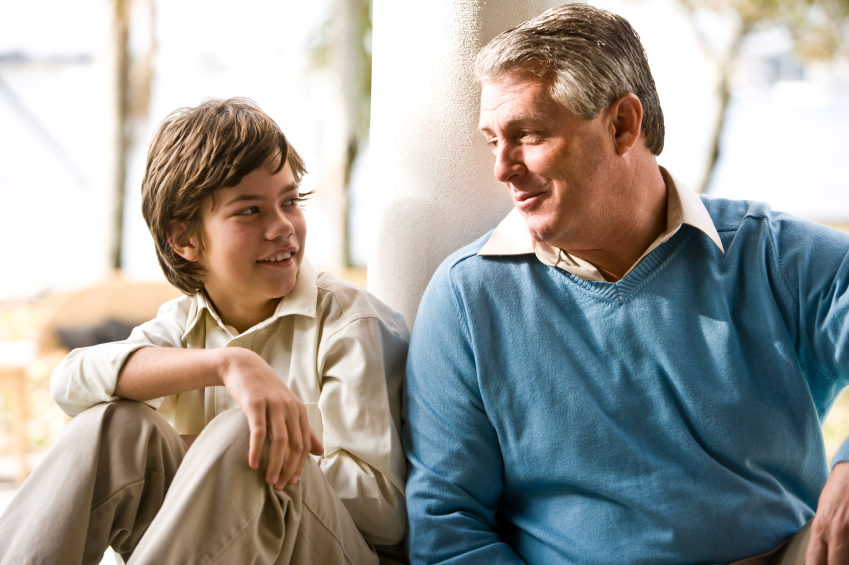 Father and son smiling and talking.